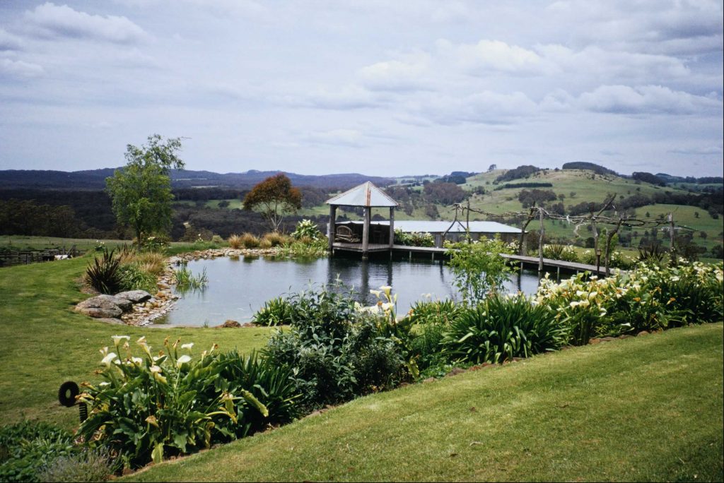 Farm dam with a gazebo and perennial borders in the managed zone of a Southern Highlands country garden