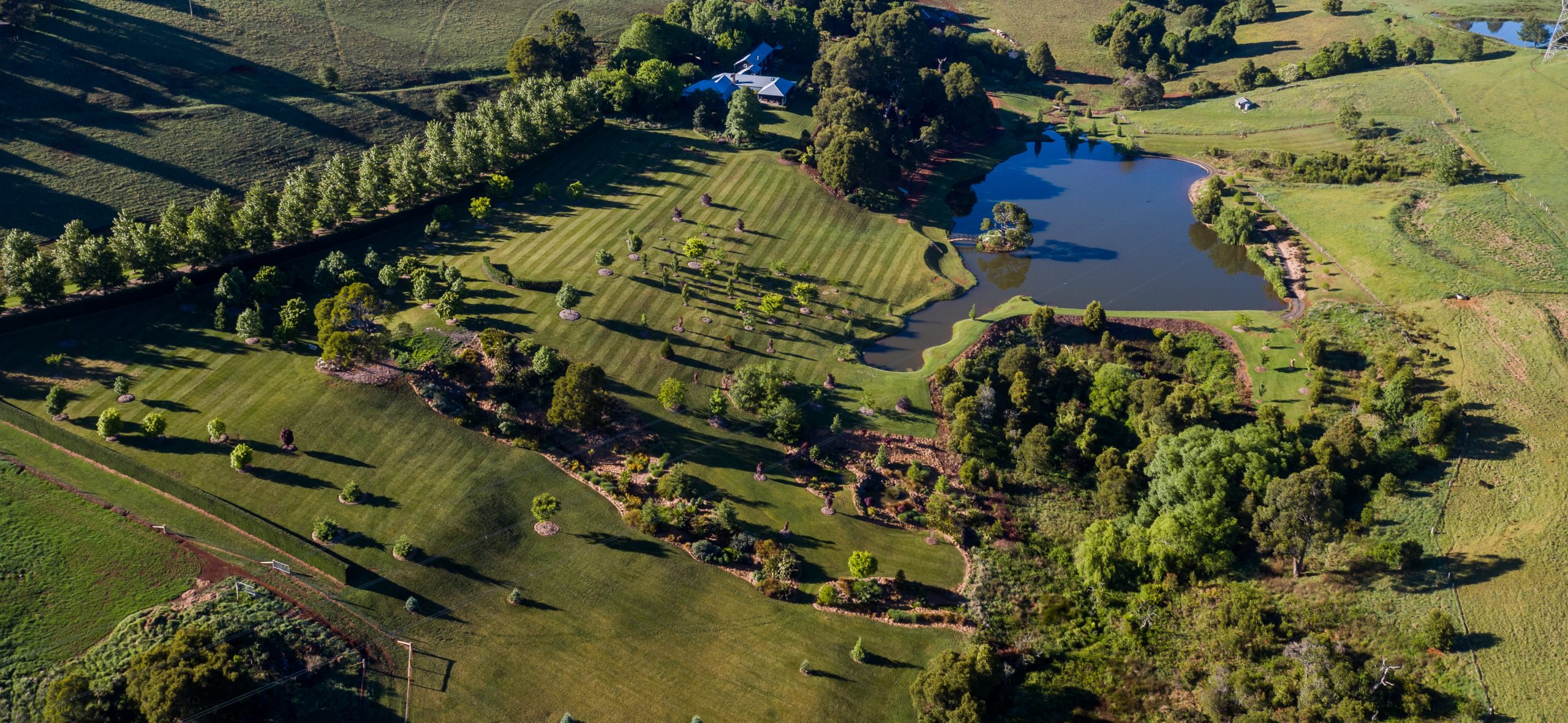 PepperTreeCreek-Nicholas Bray landscapes Aerial view of an acreage property with dam, drive and garden around the house, Southern Highlands