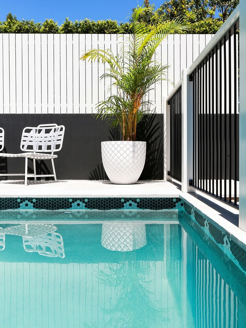 Sandstone pool surrounds, tiled pool and layered planting at a Mosman garden